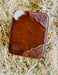 Brown leather wallet with cowhide pattern and 'KL+' monogram on a hay background