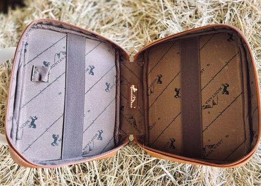 Open leather case with interior patterns on a straw background