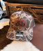 Brown Duck Camouflage baseball cap with custom branded leather patch and Richardson logo with a wooden background.