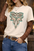 Person wearing a white t-shirt with a decorative design, brown long-sleeve underneath, blue jeans, and a belt.