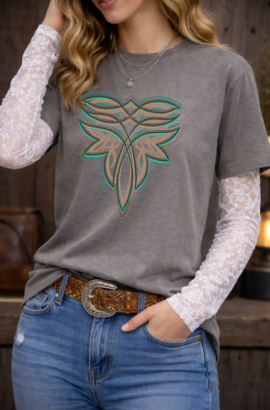 Person wearing a gray t-shirt with a leaf design, white lace sleeves, blue jeans, and a brown belt.
